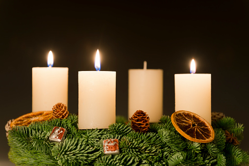 Beautiful candle with Christmas decor on white background
