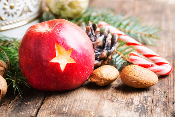 istock christmas apple with star on rustic wood 513184333