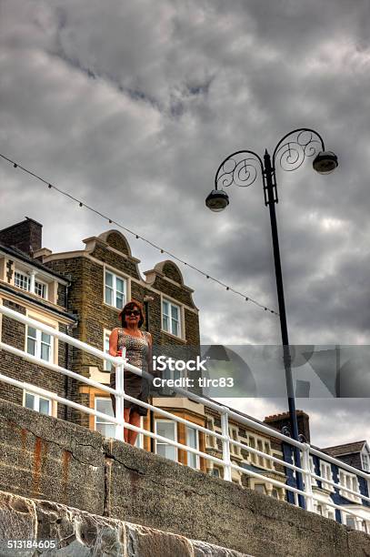 Mature Woman Standing On Seaside Promenade Stock Photo - Download Image Now - Aberystwyth, Adult, Adults Only