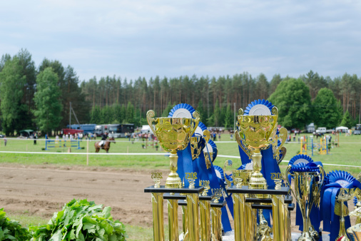 Golden trophy on shiny yellow background.