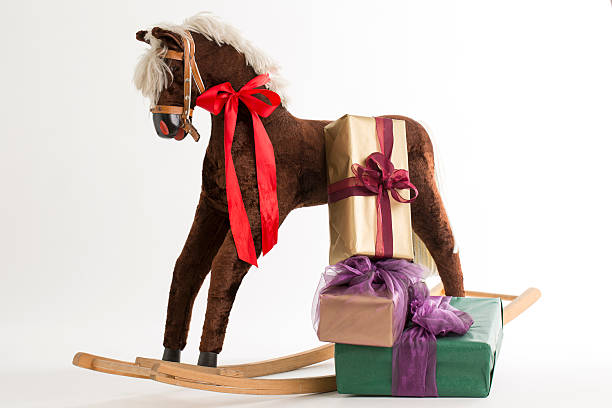 istock rocking horse and gift 513203325