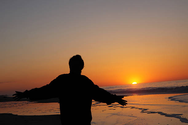 istock Welcoming the morning sun rise on the beach 513205079