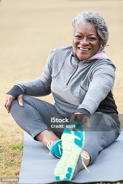 Senior Woman Stretching Stock Photo - Download Image Now - Stretching, Women, Exercising