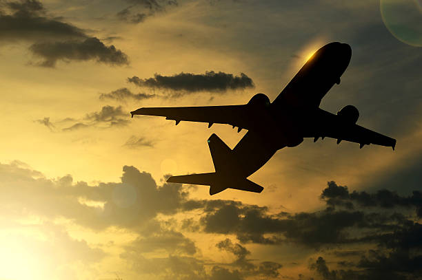 istock Plane lifting off in a calm sunset 513206795
