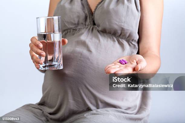 Pregnant Woman Taking Medicines Stock Photo - Download Image Now - Pregnant, Vitamin, Pill