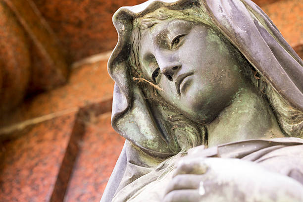 istock bronze sculpture of maria with red background 513209175