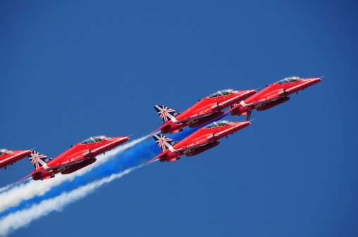 Jersey, U.K.- September 11, 2014: The British Red Arrow display team taking part in the Jersey International Airshow 2014 over St.Aubin's Bay flying with the Hawk T1 jets.