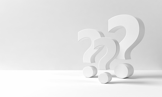 Multiple three dimensional question marks on a white backdrop resembling an indoor space with neutral background with copy space on the left side: questions, decisions, confusion.