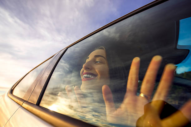 istock Woman enjoying cloudscape looking through the car window 513224968