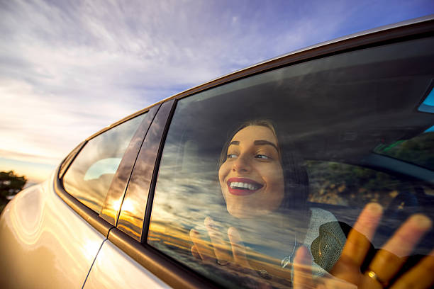 istock Woman enjoying cloudscape looking through the car window 513225064