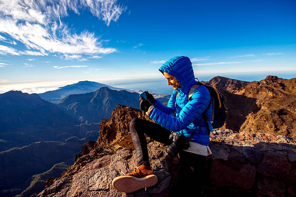Woman traveling mountains on La Palma island Woman in blue jacket and backpack traveling mountains near Andenes viewpoint on La Palma's island highest point in Spain la palma canary islands photos stock pictures, royalty-free photos & images