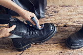 Cleaning shoes on wooden background