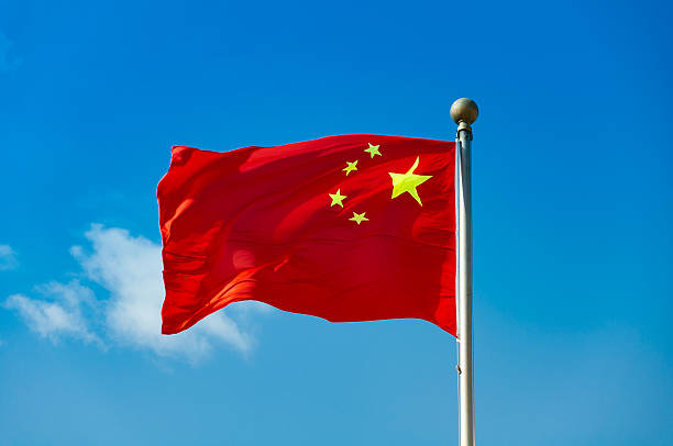 istock Chinese national flag with blue sky as background 513226286