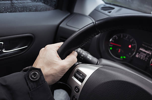 istock Male hand on steering wheel, car interior 513228826