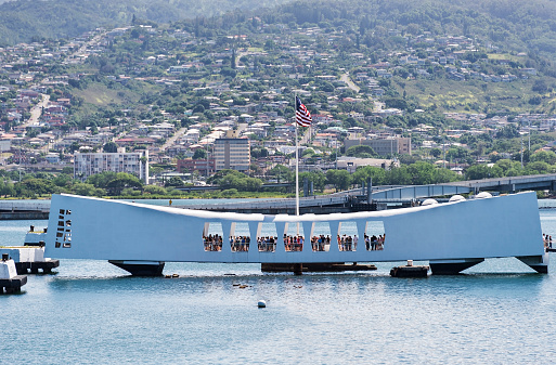 Pearl Harbor, Hawaii, USA - August 11, 2014: Tourists line the sides of the USS Arizona Memorial located at Pearl Harbor, Oahu, Hawaii.