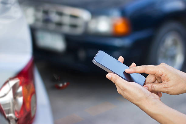 istock woman  using smartphone at roadside after traffic accident 513229412