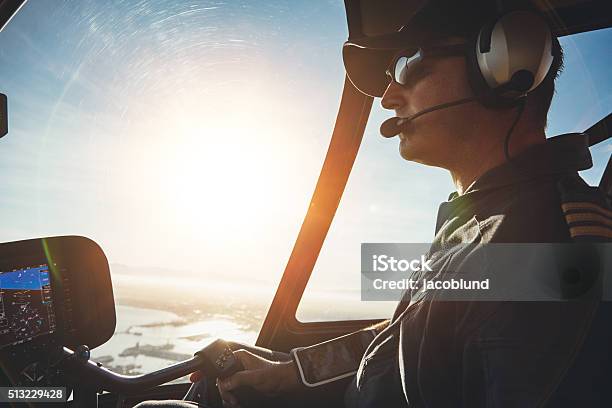 Pilot Flying A Helicopter On A Sunny Day Stock Photo - Download Image Now - Pilot, Piloting, Helicopter Pilot
