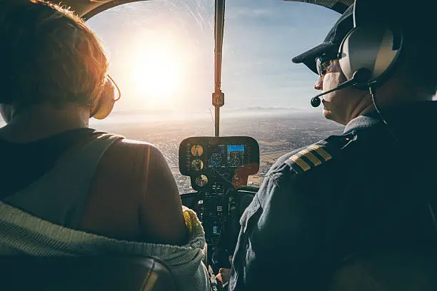 Photo of Man flying a helicopter with his copilot