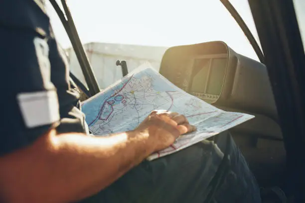 Photo of Helicopter pilot studying the flight route map