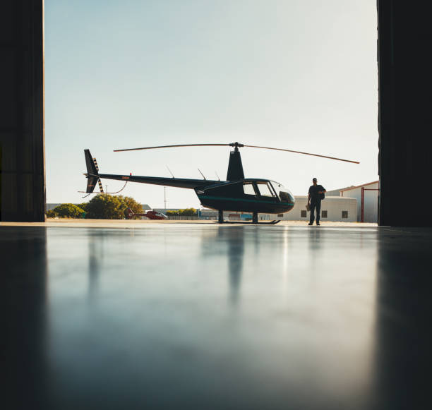 istock Silhouette of helicopter and a pilot in hangar 513229874