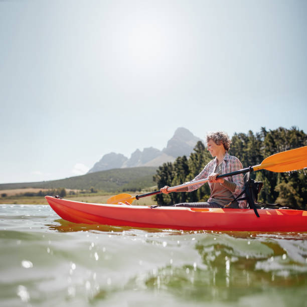 istock Senior woman canoeing on a summer day 513230312