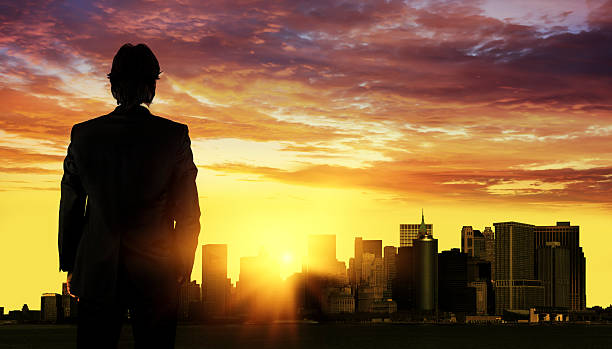 istock Man in suit facing New York skyline 513230388