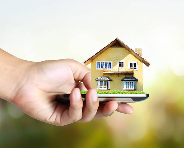 istock house on a mobile phone, in hand 513230763