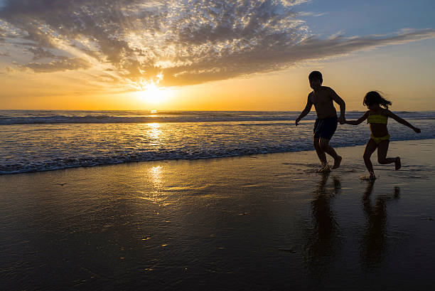 istock Children bathing on the beach at dusk 513231715
