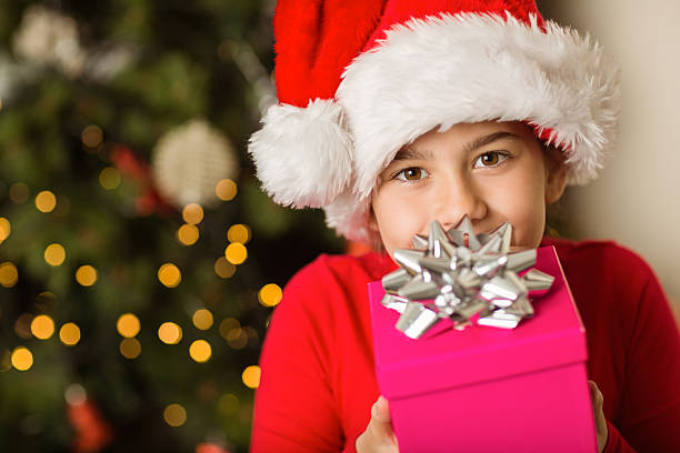 istock Festive little girl holding a gift 513232757
