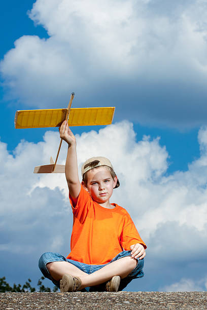 istock Little boy playing with handmade RC airplane toy 513233460