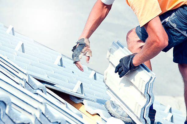 istock Tiler covering roof with new tile 513233658