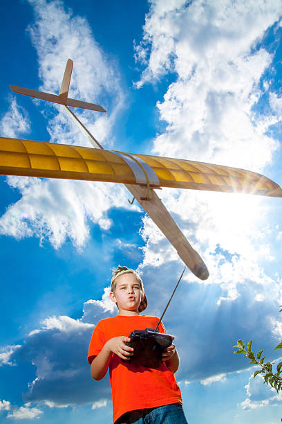 istock Little boy playing with handmade RC airplane toy 513233686