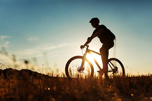 istock Man Cyclist with bike on sunset 513235860