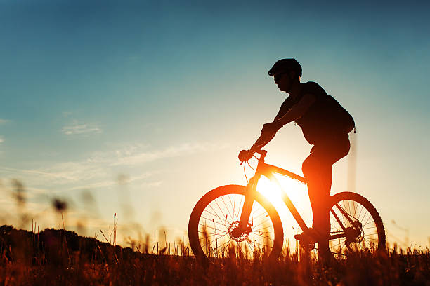 istock Man Cyclist with bike on sunset 513235960