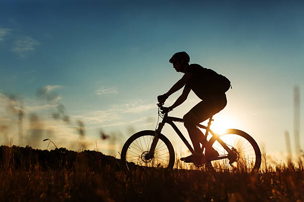 istock Man Cyclist with bike on sunset 513236086