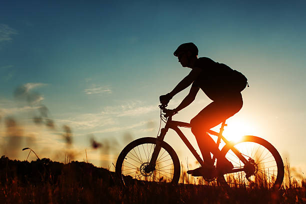 istock Man Cyclist with bike on sunset 513236162