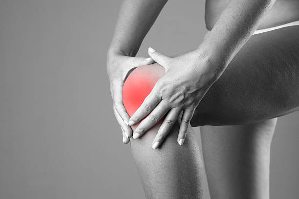 istock Pain in the knee on a gray background 513236820