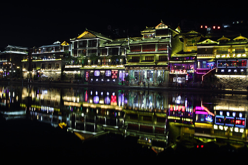 Fenghuang, China - September 16, 2015: View of illuminated riverside houses in ancient town of Fenghuang known as Phoenix, China