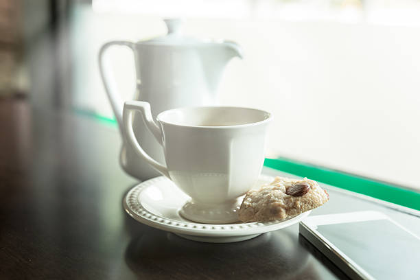 istock cup of tea with almond cookies 513237546