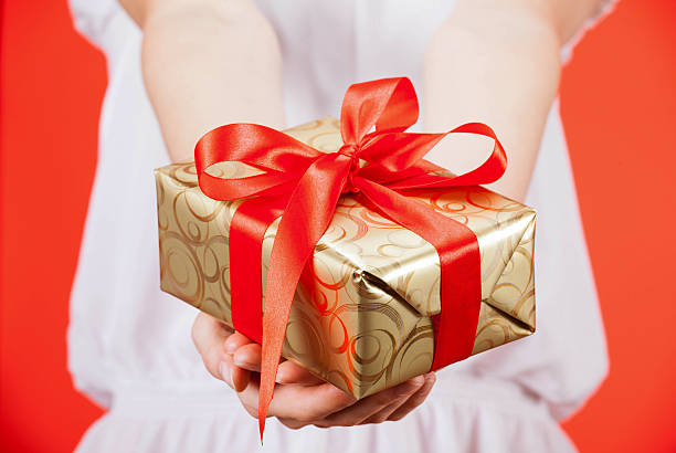 istock Woman holding a gift 513238158