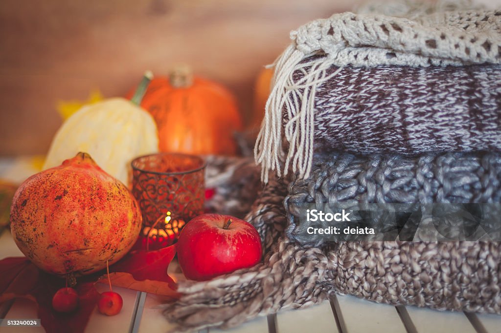 Still life autumn decoration Still life autumn decoration made with pumpkins, apples, pomegranate, woolen scarves and candle Autumn Stock Photo