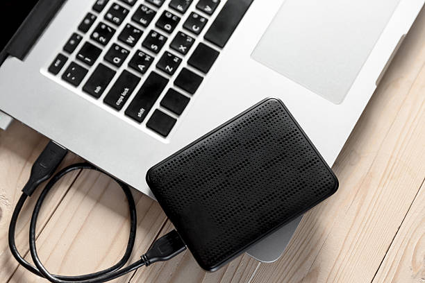 istock portable hard drive and laptop computer 513240402