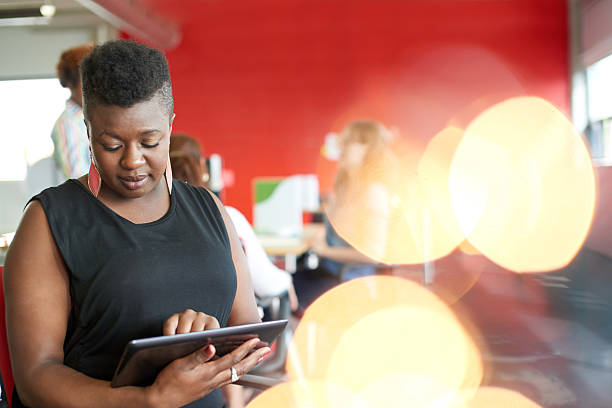 istock Confident female designer working on a digital tablet in red 513240496