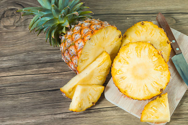 istock pineapple on the wood texture background 513244138