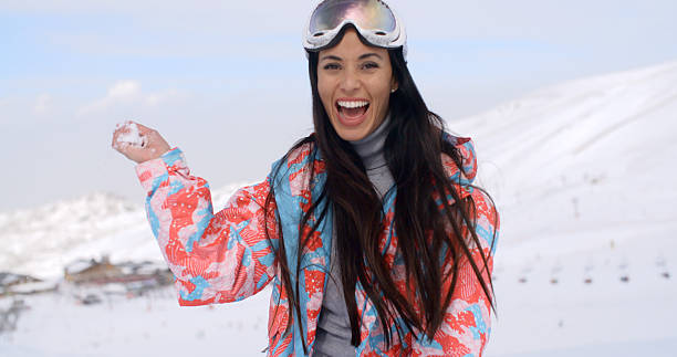 istock Laughing young woman throwing a snowball 513244870
