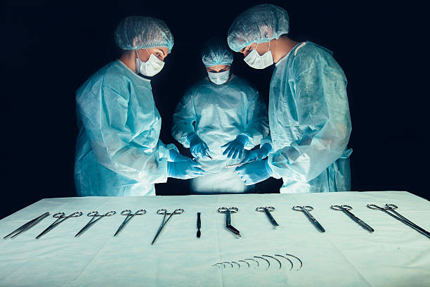 istock Medical team  hospital performing operation. Group of surgeon at work 513245432