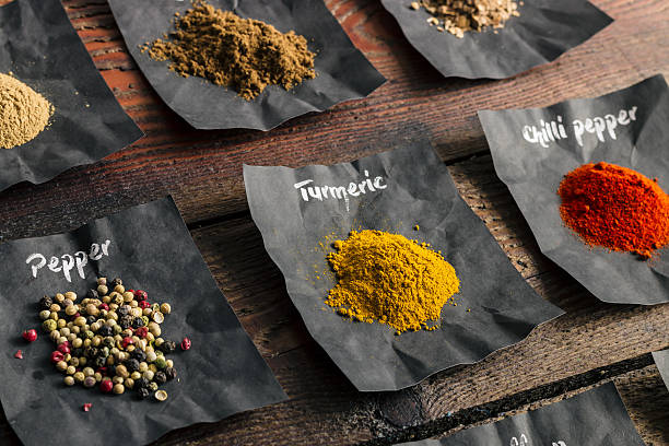 istock Colourful spices on wooden table 513248178