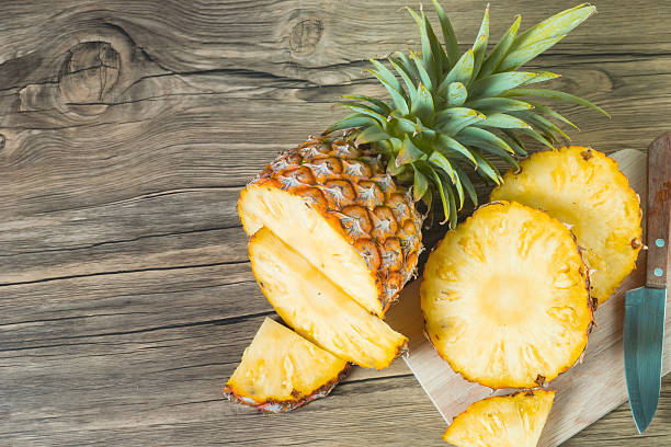 istock pineapple on the wood texture background 513248680