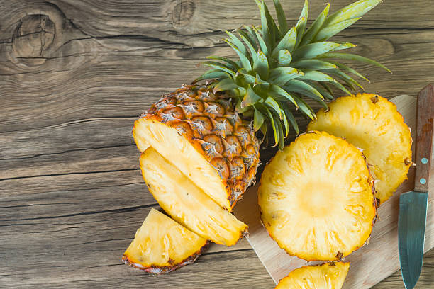 istock pineapple on the wood texture background 513250754