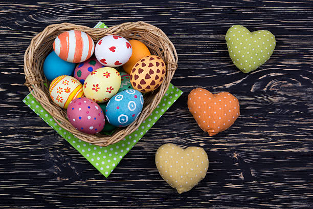 istock colorful easter eggs in a basket on wooden background 513251054